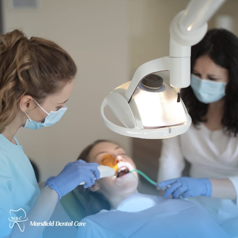 Dental emergency treatment in progress—dentist using tools on a patient wearing protective eyewear at Marsfield Dental Care.