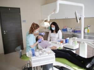 Professional dentist treating tooth pain caused by hot food, providing relief and care for sensitive teeth.