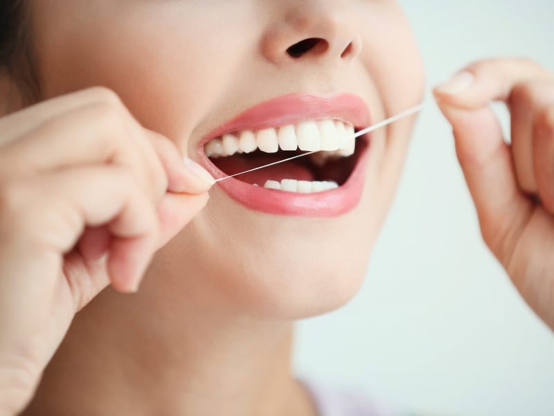 Flossing is essential for maintaining dental crown longevity.