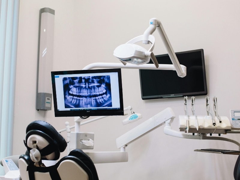 Dental X-ray panoramic image displayed on monitor in modern dental clinic operatory